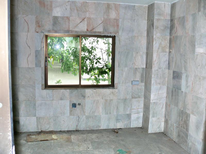 P1000067.JPG - This hideous tile in the planned kitchen area will be gone-- and likely the window will be replaced as well.