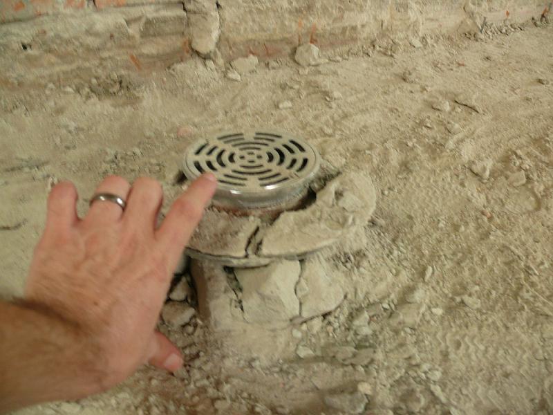 P1000282.JPG - This drain in the kitchen reveals just how thick the old concrete floor slabs were-- that drain was once flush with the floor surface.