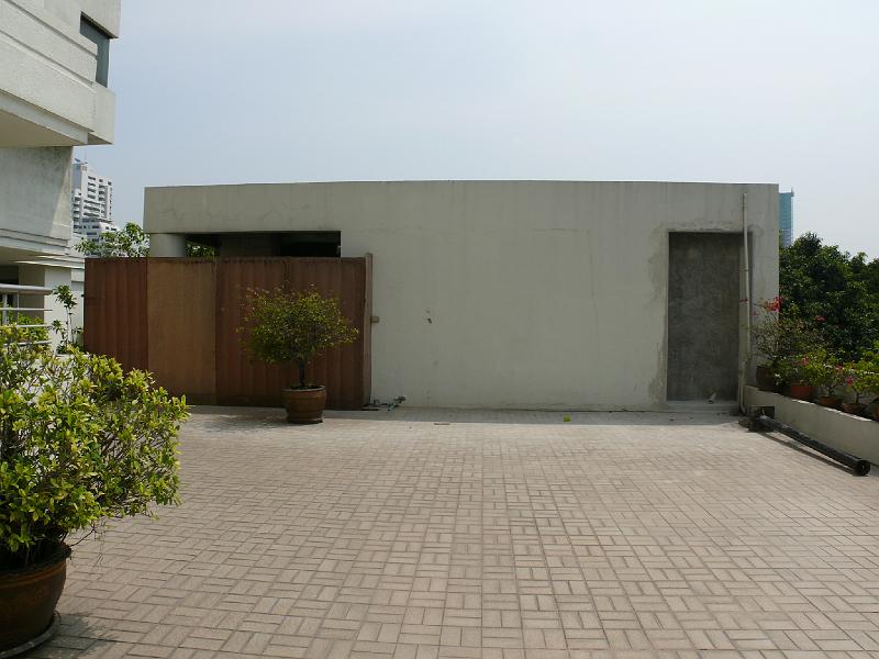 P1000402.JPG - Welcome back to the exterior. Jon conferred with the A/C specialist and decided to build a niche to contain the compressors. (right side) The niche cuts a bit of space out of the utility closet.