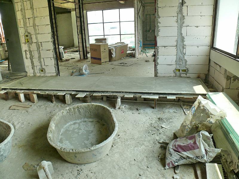 P1000443.JPG - In previous photos you saw a metallic frame for the seating area. I had no idea that this was to be a container for poured concrete. Once the cushions go on we won't ever have to worry about a sagging base!