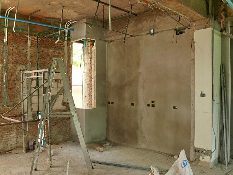 P1000462.JPG - The right kitchen wall is now slathered in cement. The refrigerator will be placed toward the right of that wall.