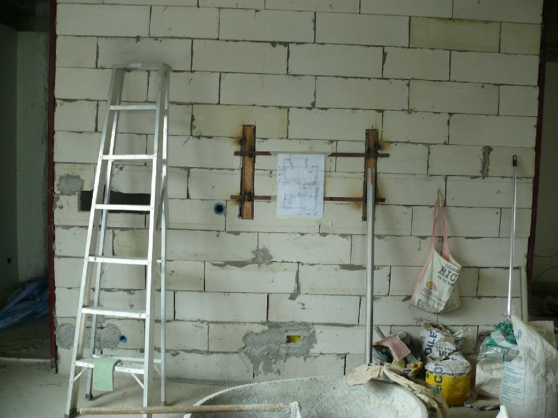 P1000473.JPG - The living room wall. Now that the work is converging more on details, Jon's project manager posted the floor plan with dimensions. (You can see the more generalized plan for yourself in the "Floor Plan" web gallery one level up from this photo gallery.) The next photo is a close-up of this posted plan.