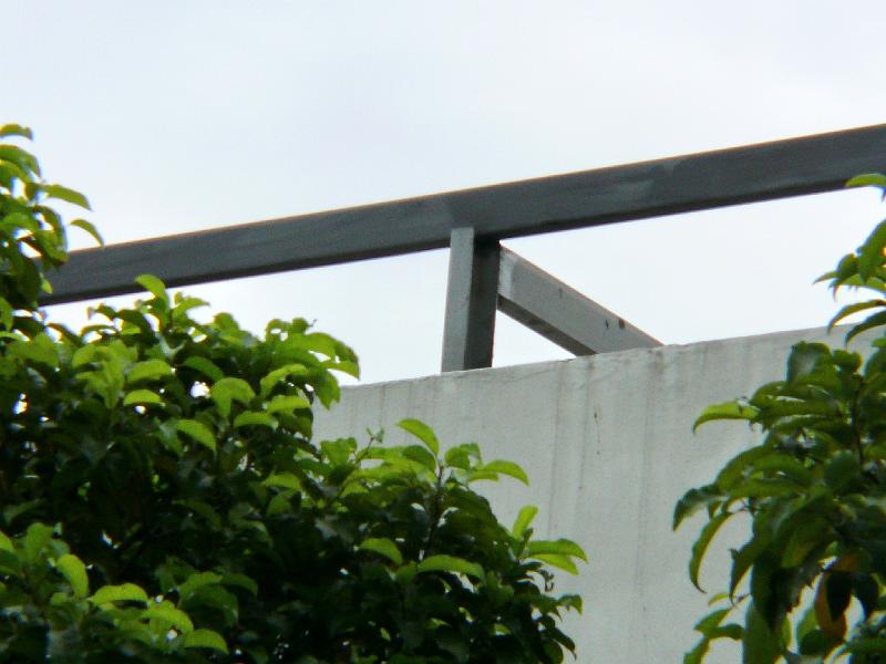 P1000491.jpg - A closer look at the structural members supporting the super-roof. 

Energy conservation and comfort are design goals. Jon's still mulling over the possibility of adding a fan to exhaust accumulated hot air in the gap. There will also be the customary insulation in the interior between the false ceiling and concrete roof. (Jon's also ordered dual-glazed windows to replace those full height windows in the interior.