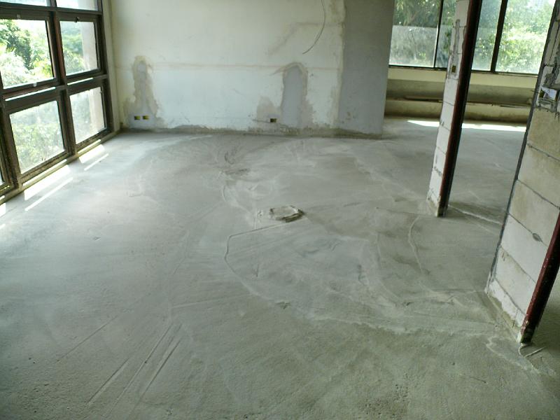 P1000499.JPG - This picture was intended to show the state of the newly poured concrete for my work area. But it also shows the newly installed frames for casement windows. (The original windows did not open!) Jon said that when the glass was temporarily removed, yesterday's breeze made the apartment quite pleasant.

Double pane glass will be installed into the frames shortly, promising lower heat infusion during the most extreme days. (Fortunately this is a northeastern exposure so there won't be extended sun beating down all afternoon.)