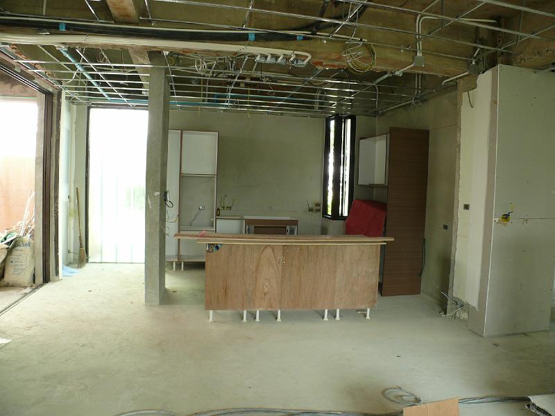 P1000567.JPG - The kitchen now has cabinetry in place. Facings and countertop are yet to be installed.

You'll notice that the latticework is now in place making way for the drop ceiling. (Some parts of the unit already have the ceiling in place as you shall soon see.)