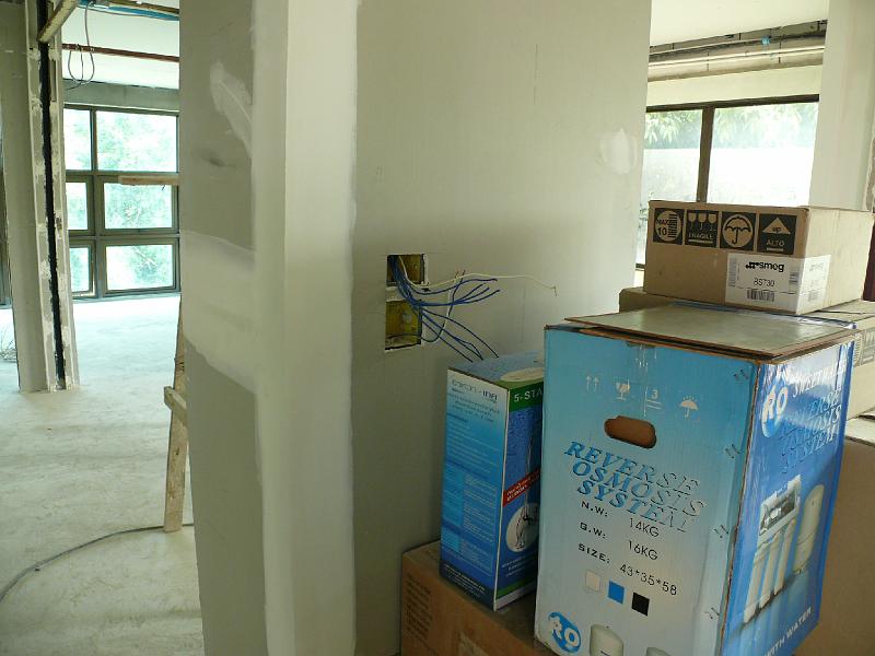 P1000600.JPG - Wiring is in place awaiting switch plates. The tall blue box holds the water filtration system we picked out just 48 hours ago.