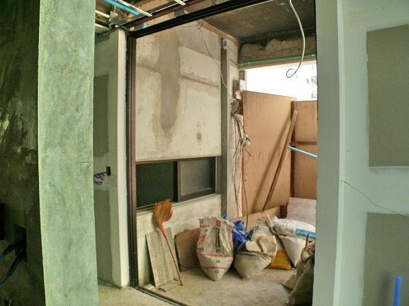 P1000603.jpg - The frame for the sliding entrance door is in place. The doors themselves are due this coming week. Jon's office window is installed (lower center of photo).