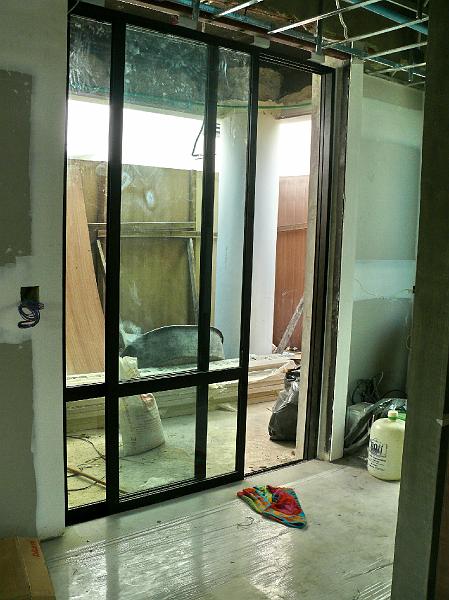 001-P1000645.JPG - The frame for the sliding front door has been installed. Shortly the upper panels will contain translucent glass while the lower ones will be clear.