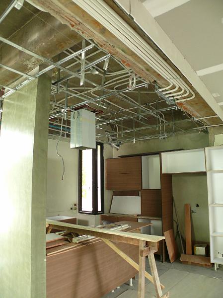 002-P1000661.JPG - Every possible pipe and wire has now been snaked through the kitchen ceiling. The vent conduit has been installed for the floating oven exhaust hood.