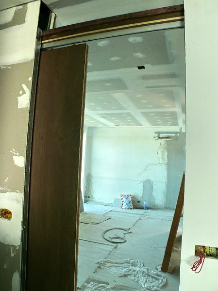 P1000697.jpg - The view from the master bath into the master bedroom and my work area. (A cabinet will appear in the center of the space to serve as a delineation between the two areas.)