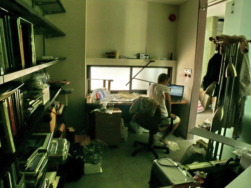 P1000806.jpg - Jon's office already looks lived in. Because it is the only totally finished room for key services (electricity, lighting, A/C), it has become Jon's refuge. Unfortunately it is also where we are stashing a lot of items until the dust settles-- literally.