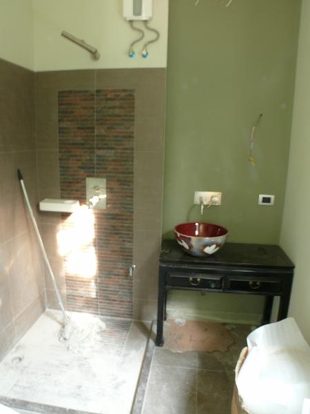 P1000815.JPG - Jon's designer instincts give the guest bath a distinctive touch. This is the popular new trend-- a wash bowl atop a furniture-like stand. In this case, Jon sought out a real table that will complement occasional furniture in the guest room. (The enclosure will be installed soon.)