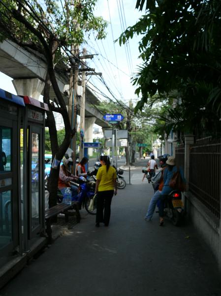 P1000109.JPG - Note the blue street sign marking Soi 53 at the corner. When you want to zip quickly anywhere in the neighborhood, catch a ride with one of the motorcyclists who cluster at this corner.